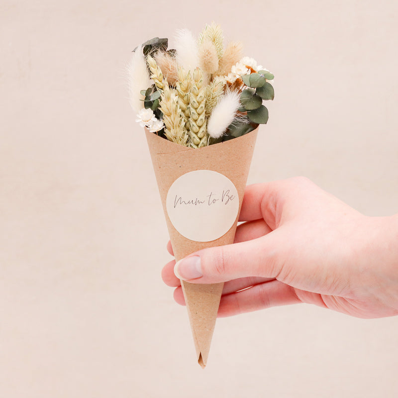 Neutral green & white dried flower posy with 'mum to be' sticker in a kraft cone