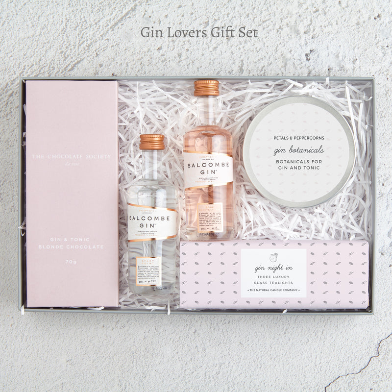 The 'Gin lovers' letterbox gift set containing two miniature gin bottles, gin botanicals tin, gin night in tealights and gin & tonic chocolate bar in pink packaging