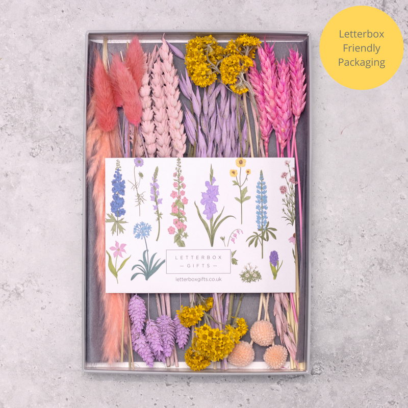Bright summer pink, purple and yellow dried flowers arranged in a letterbox-friendly gift box