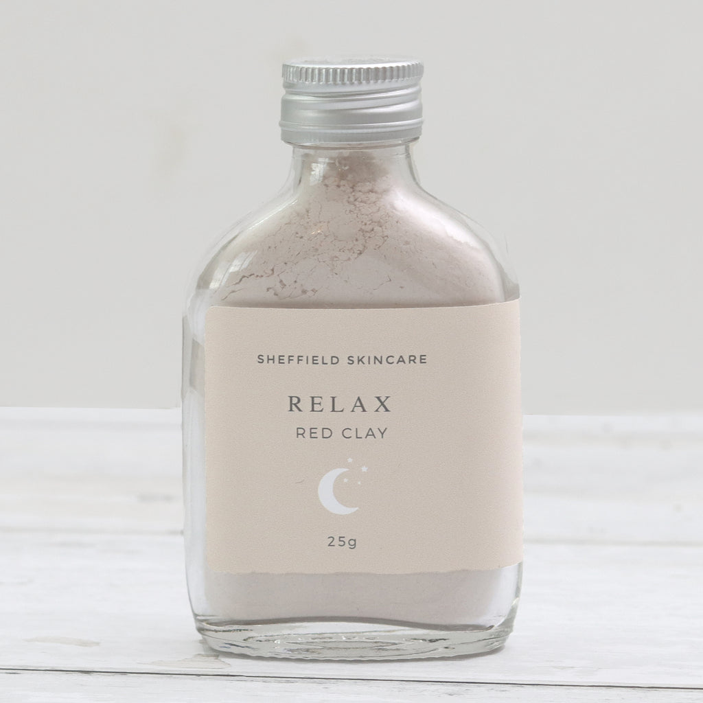 Relax red clay face mask in a glass bottle