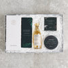 Letterbox-friendly 'man box' gift set containing dark chocolate, tealights, whisky miniature, soap and bath salts in dark green packaging