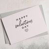 Pastel pink greetings card with Happy Valentines Day text and a heart image