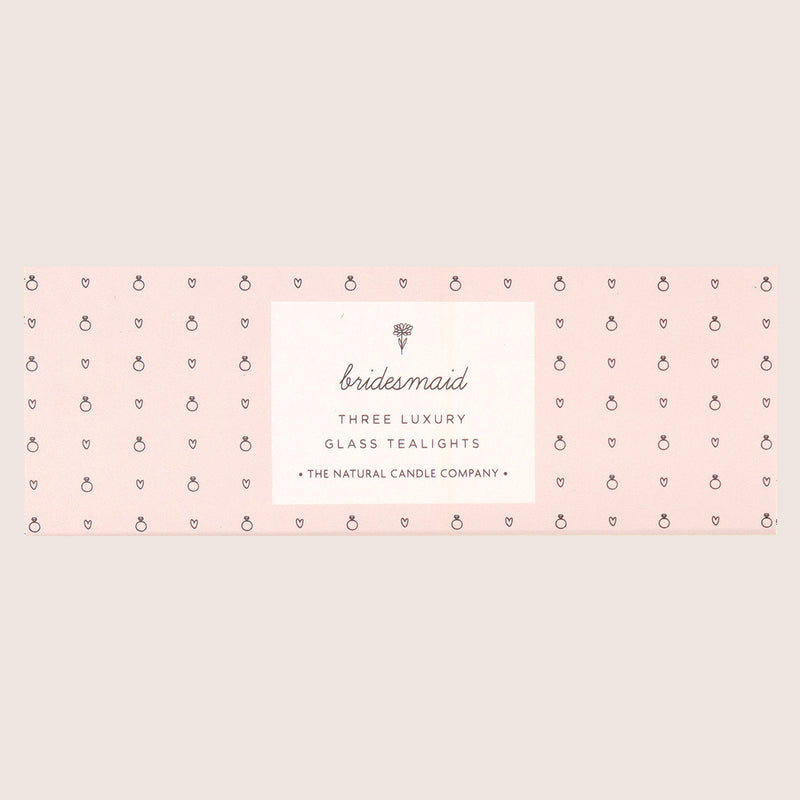 three 'bridesmaid' glass tealights in pale pink sleeve with small rings and heart images