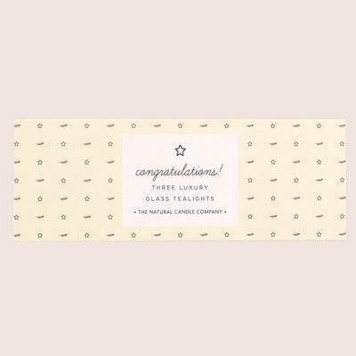 three 'congratulations' glass tealights in pale yellow sleeve