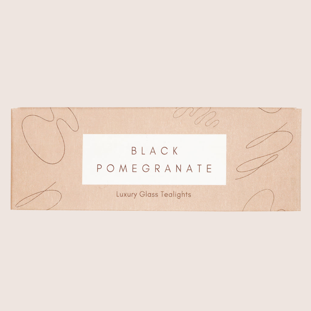 Three black pomegranate glass tealights in a brown gift box
