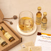 Close up of miniature whisky tasting set bottles and whisky in a glass