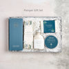 Pamper gift set containing chocolate bar, tealights, clay face mask, soap and pink bath salts in blue and green packaging